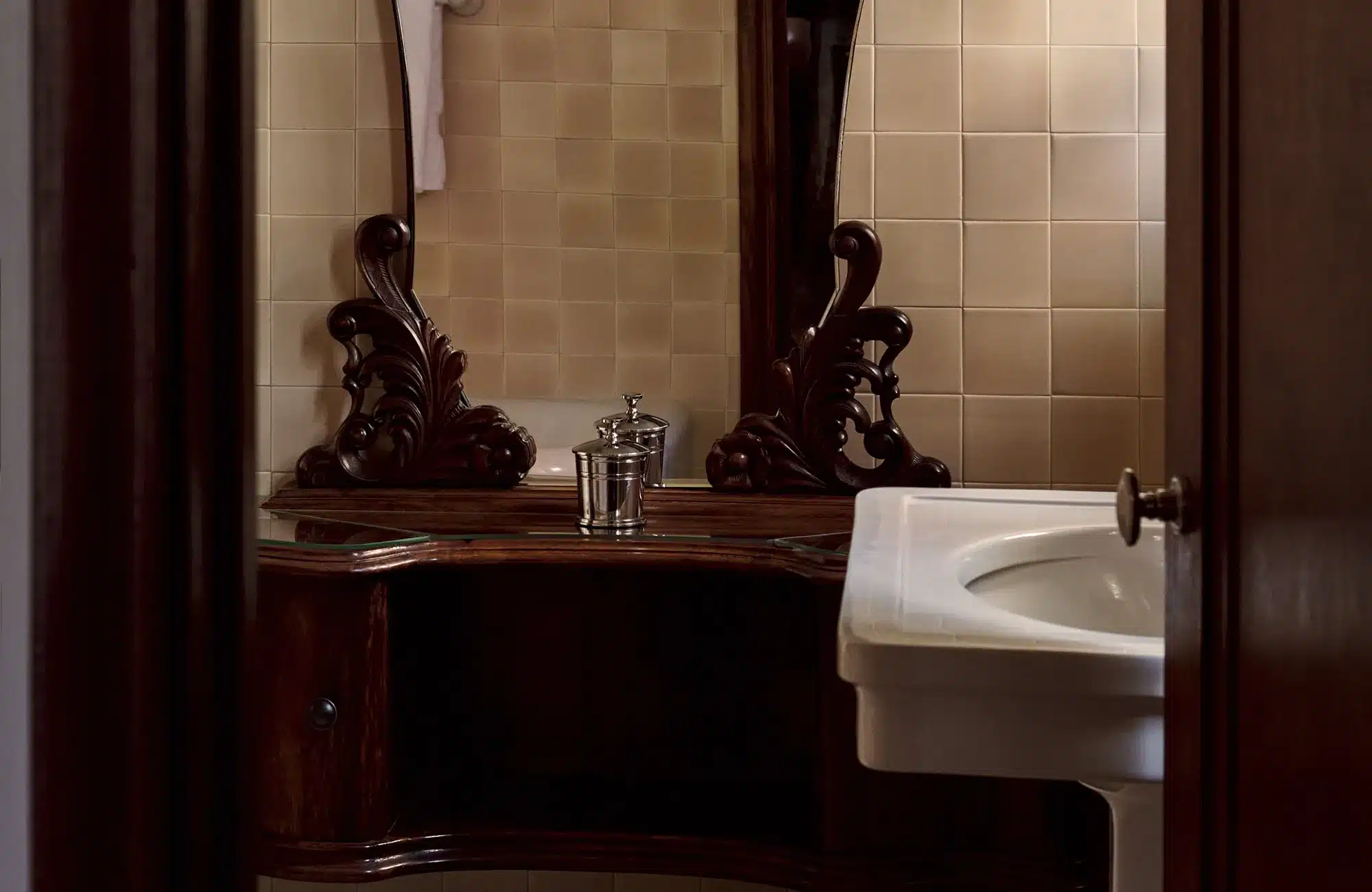 Library room bath sink and mirror with silver canister