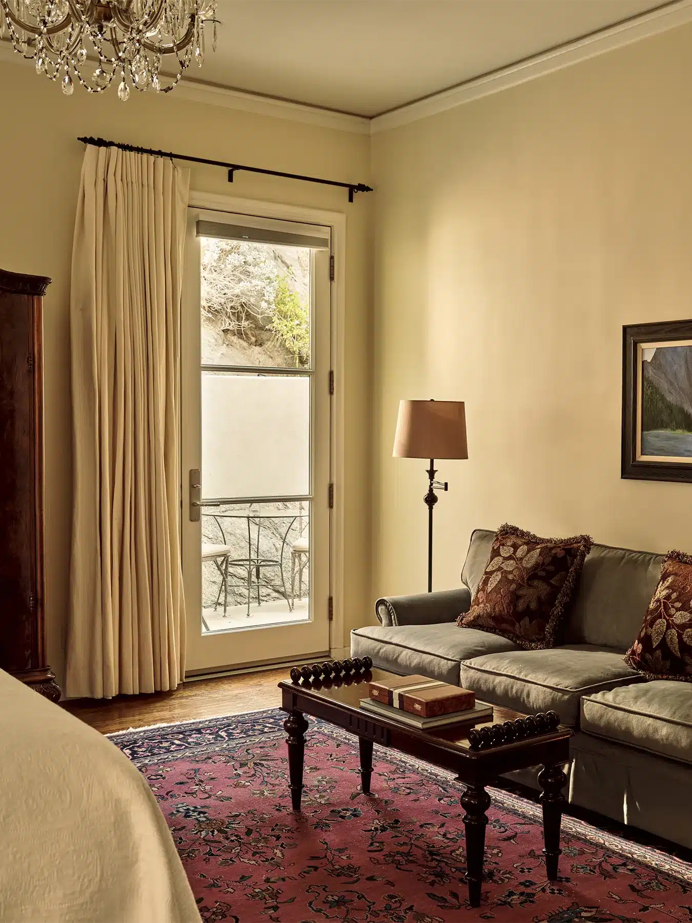 Fountain room with couch, coffee table, and door leading to patio