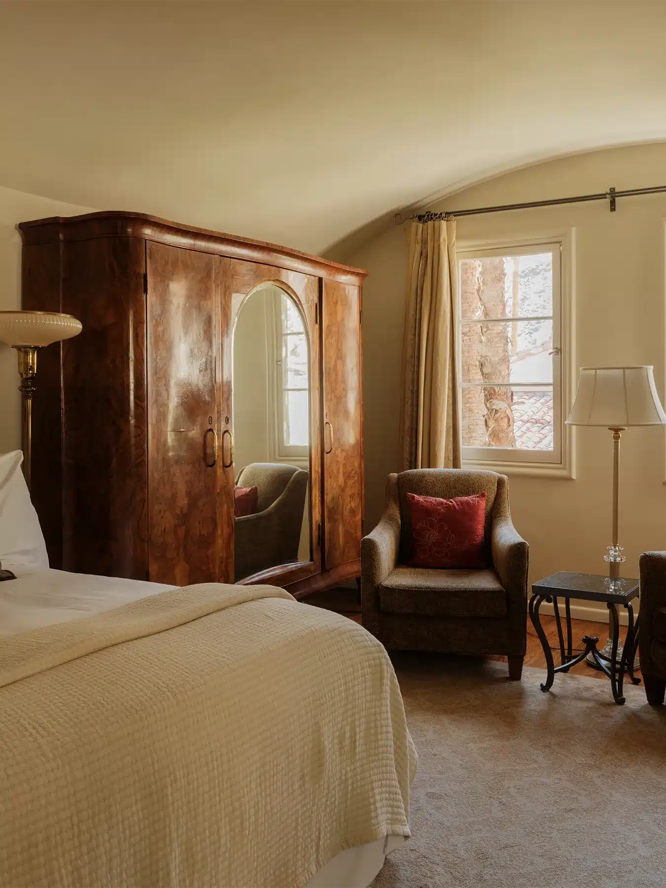 Loft room with bed, armoire, chair, and side table