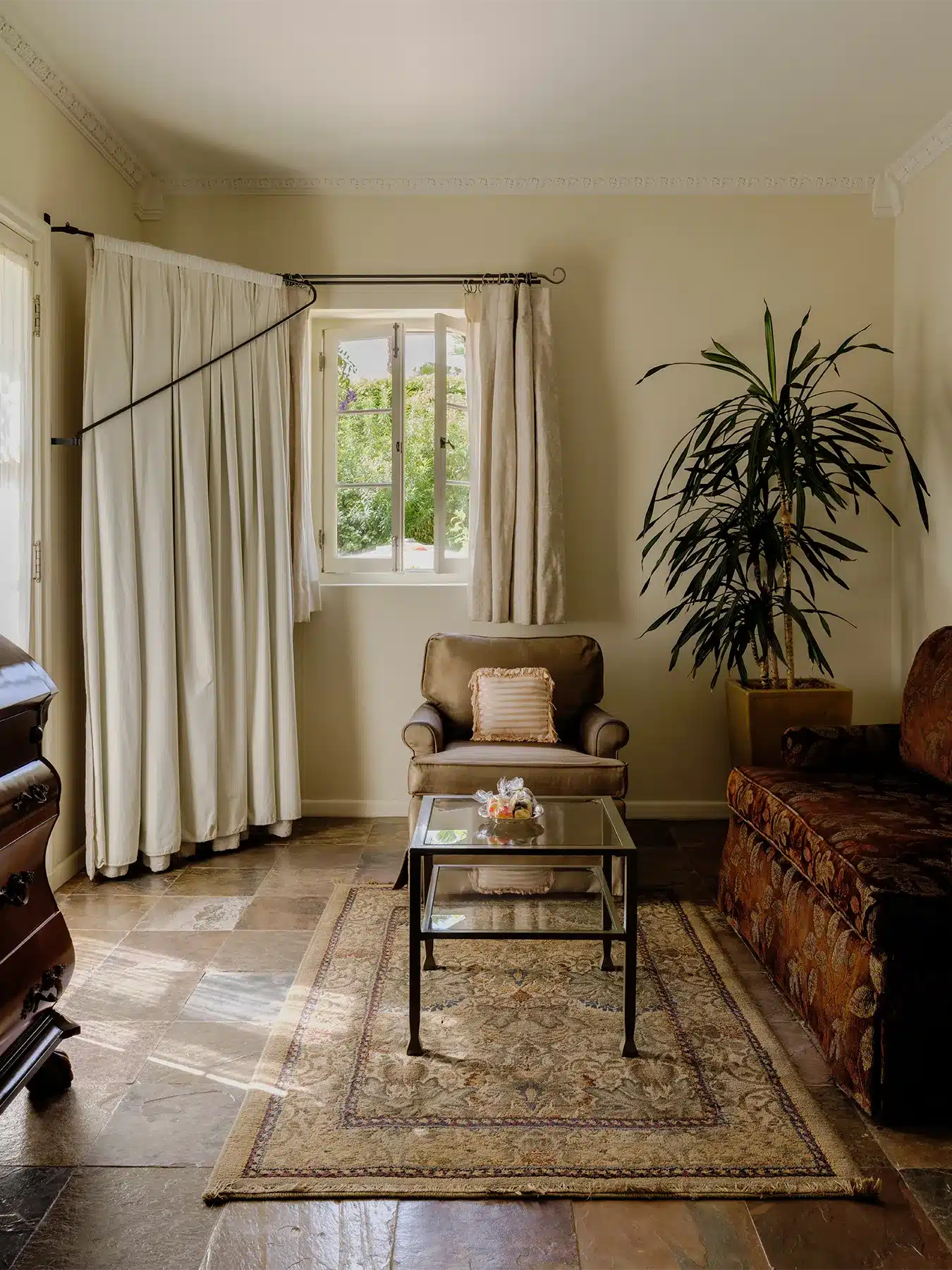 Palm room seating with chair and couch, and window open