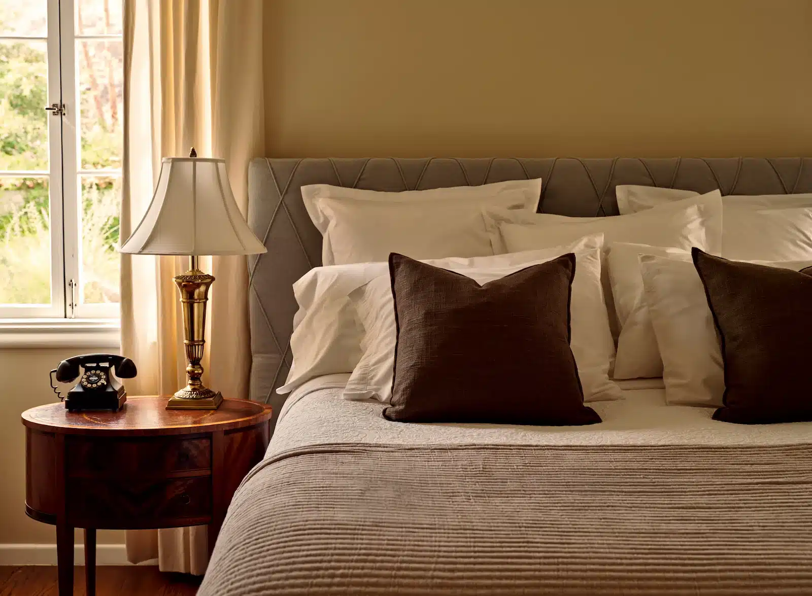 Fountain bed with side table under window