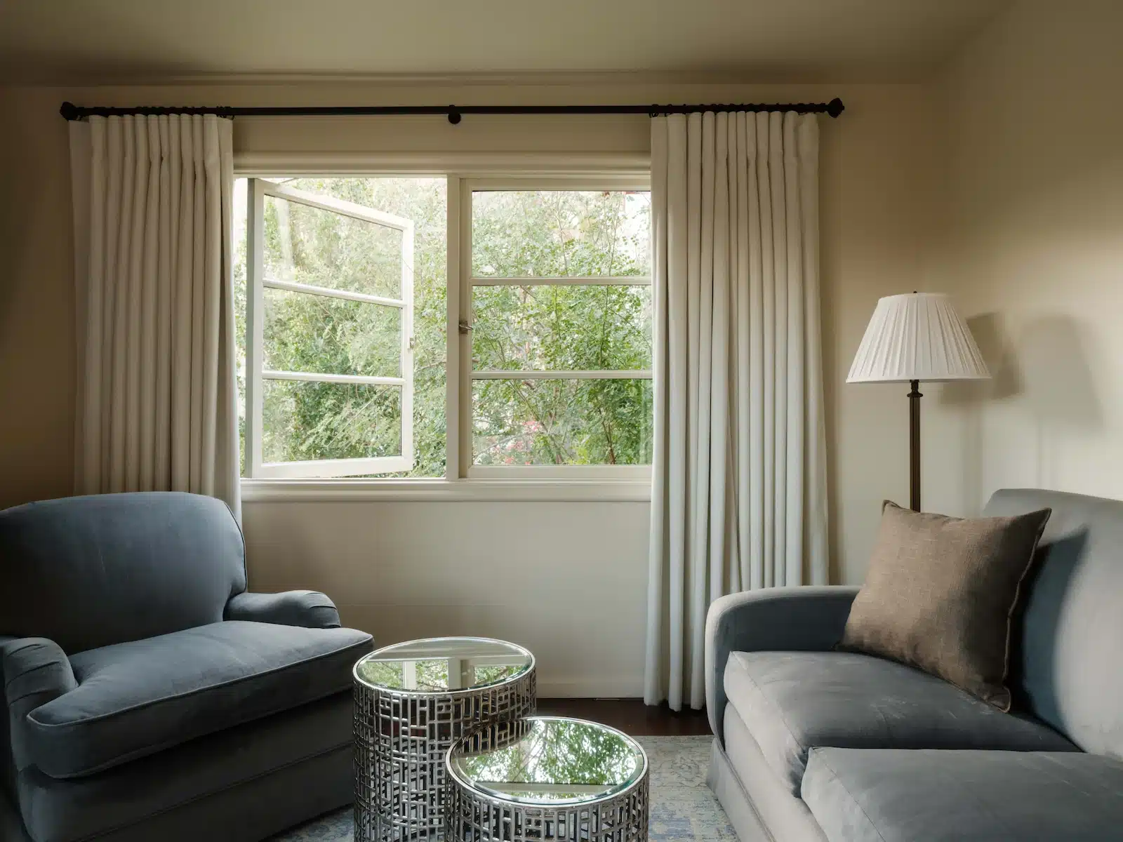 Tahquitz sitting area with chair and couch under open window